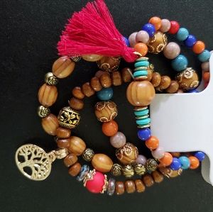 Set of 4 bracelets. With tree charm and tassel.